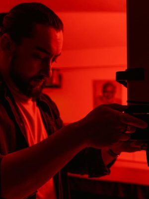 Man in Red Button Up Shirt Holding Black Smartphone